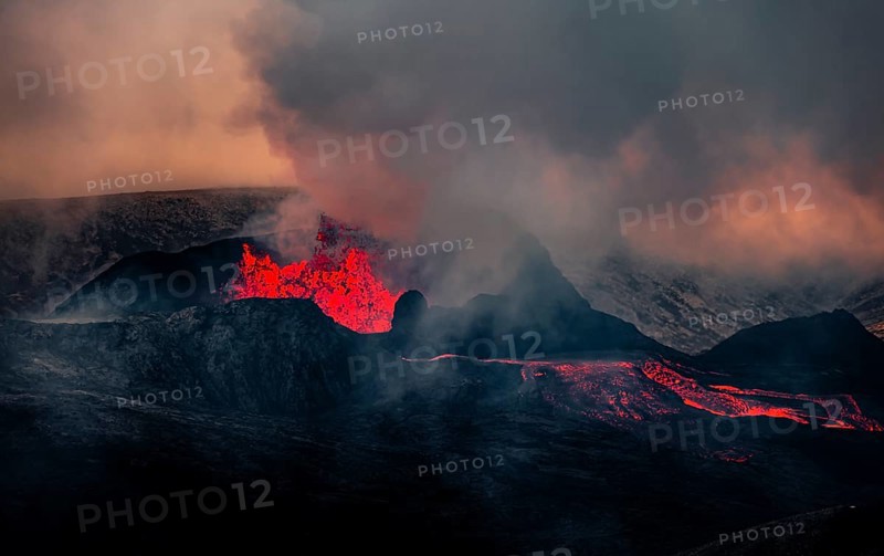 Erupting volcano with lava fountains and lava field