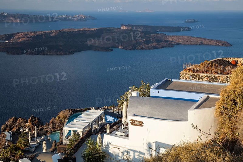 Terrace with pool of a small hotel with a view over the blue sea