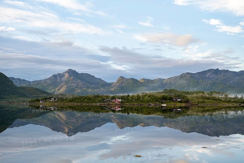 Mountains reflected in fjord near Laukvik
