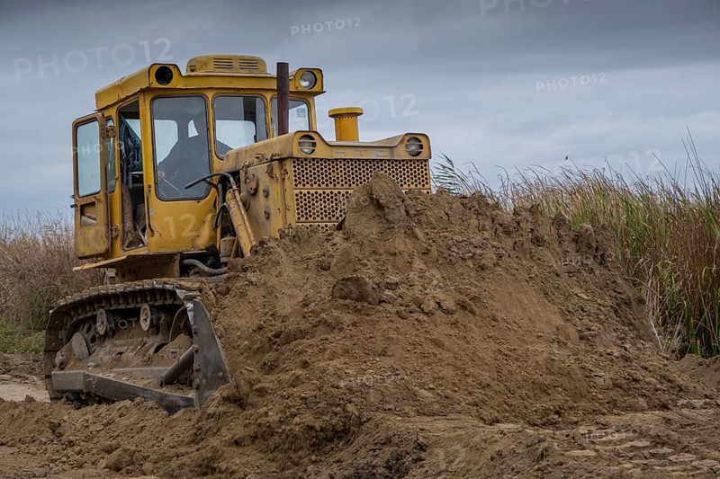 Bulldozer removes dam in the delta Danube river