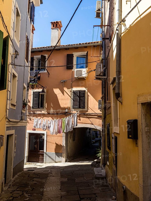 Laundry hanging to dry in a narrow alleyway of the old town of Izola