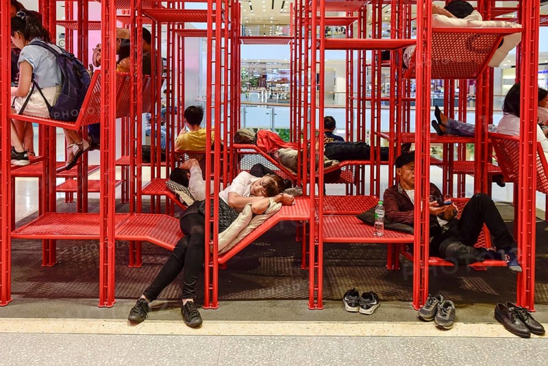 Red iron rack with seating and lounging area for customers to rest