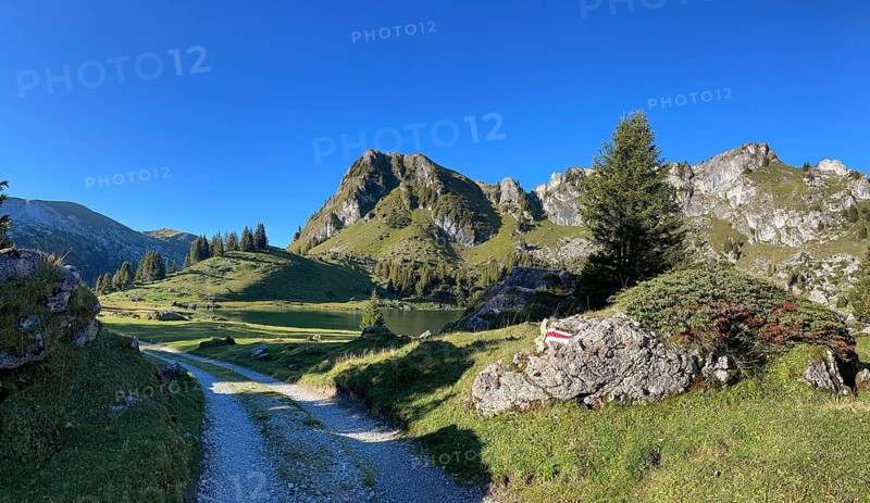 Hiking trail marking on a stone at Seebergsee