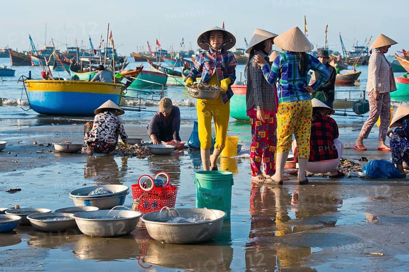 Fishermen on the beach with freshly caught fish and seafood