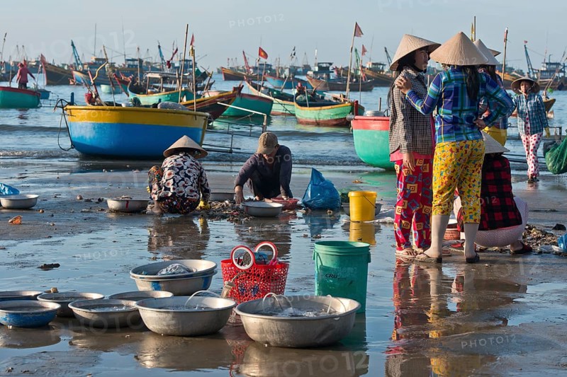 Fishermen on the beach with freshly caught fish and seafood