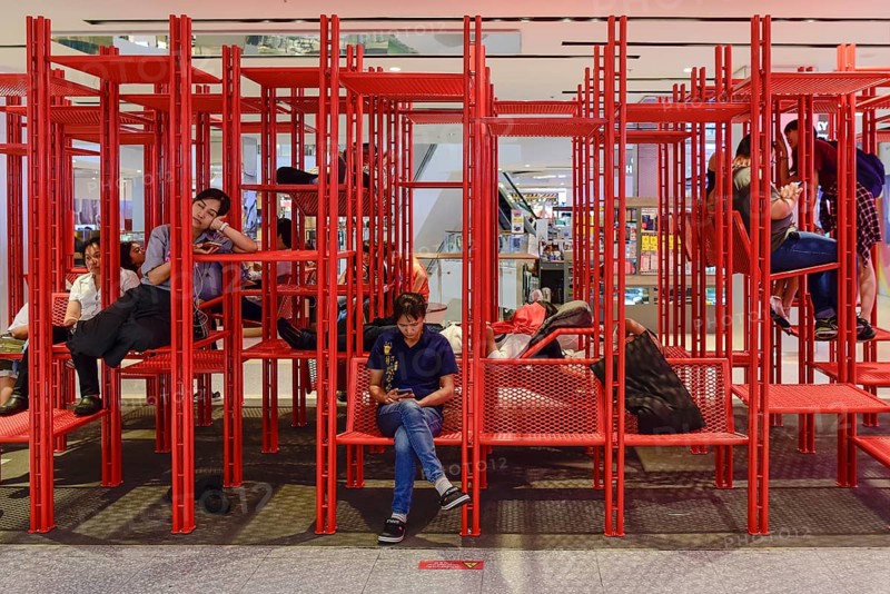 Red iron rack with seating and lounging area for customers to rest