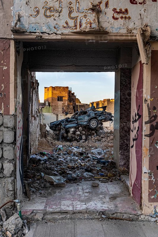 Demolished car in a destroyed house from ISIS
