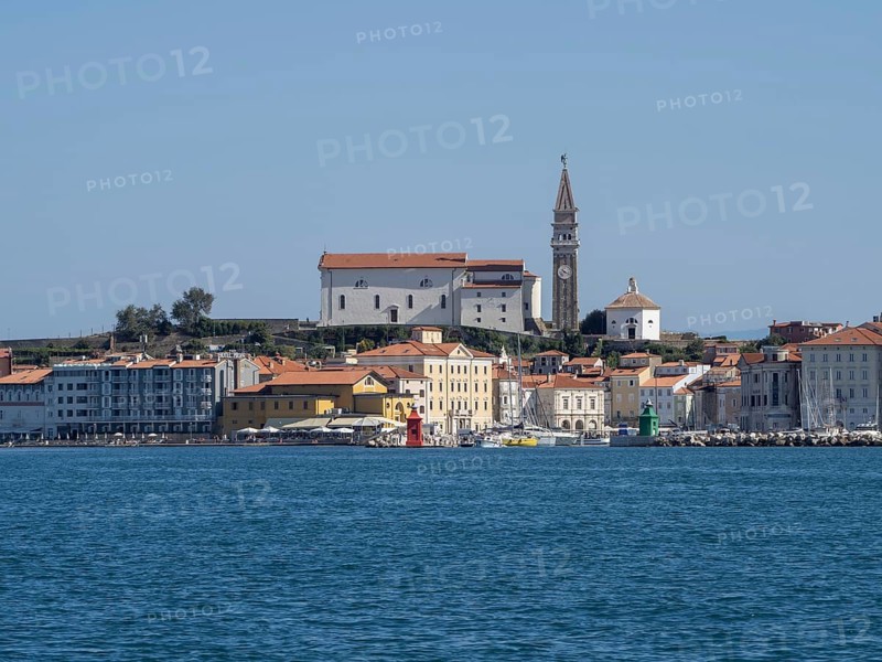 View from the sea to the harbour entrance of Piran