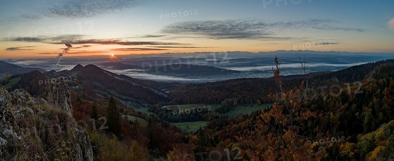 Sunrise with autumn fog with alpine panorama