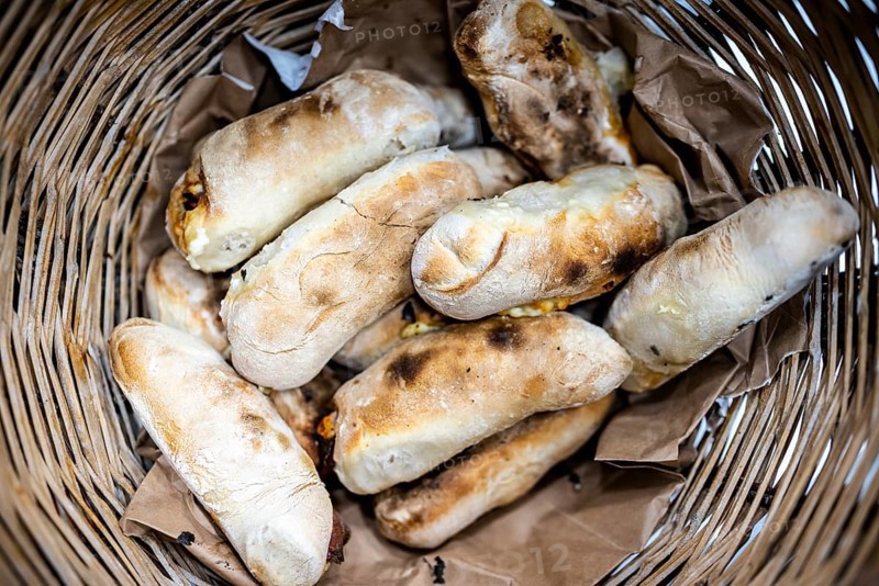 Traditional bread rolls with cheese and chorico meat baked in wood-fired oven