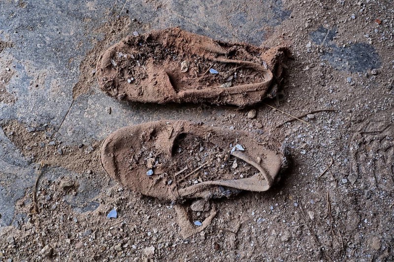 Pair of dilapidated canvas shoes from above
