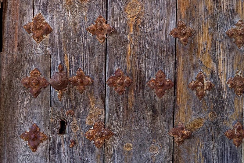 Old wooden door with fittings and keyhole