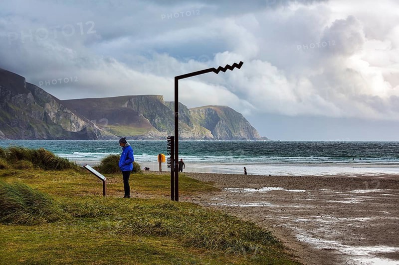 Person reading information board at Keel Strand viewpoint