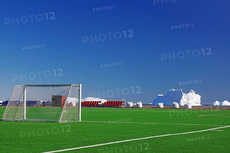 Football ball with goals in front of icebergs