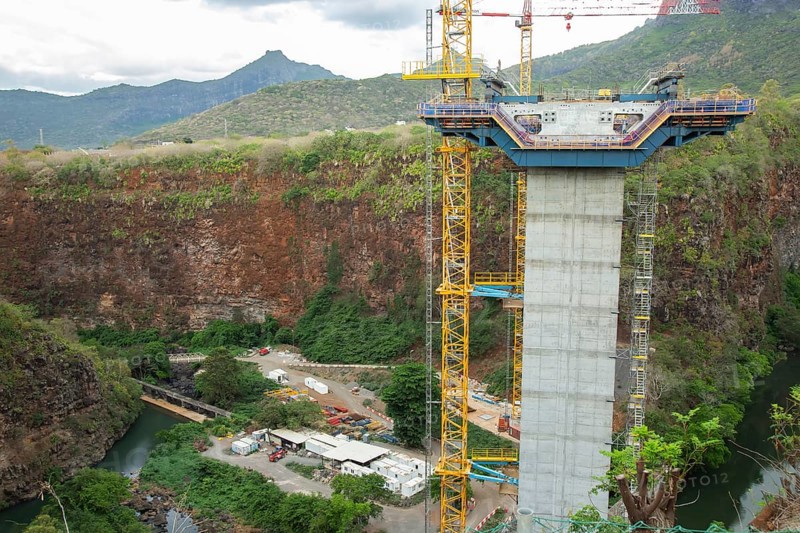 Construction site of bridge with crane across the Grand River of North West near the city of Beau Bassin