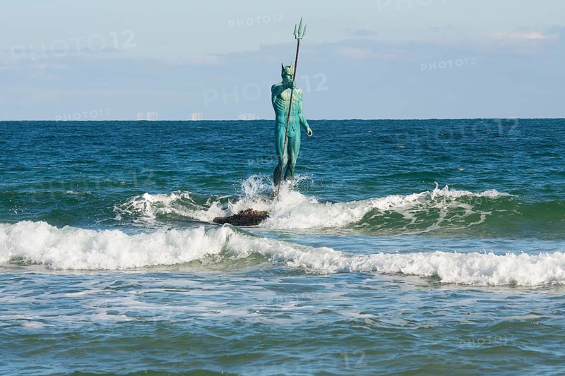 Sculpture of Neptune in sea near the beach