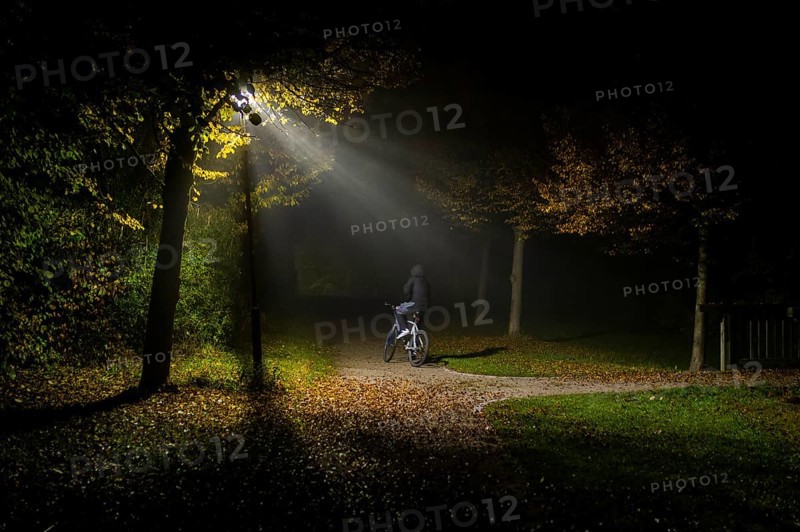 A person rides a bicycle through a lonely park in Markt Swabia