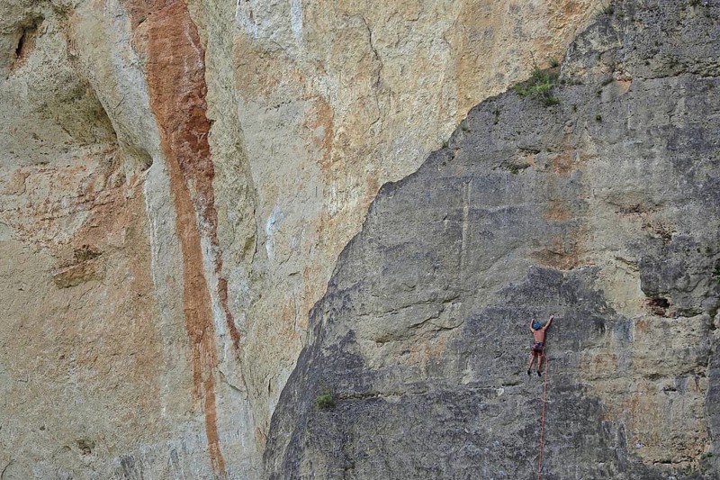 Climber on rope in rock face