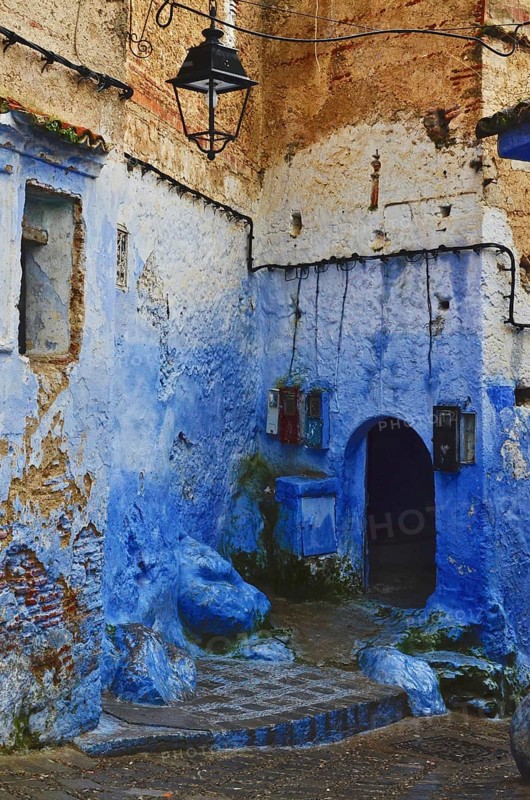 Blue house corner with archway in an alley