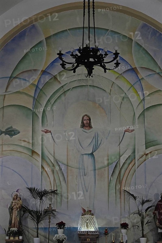 Mural of Jesus with outstretched arms in church