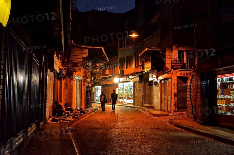 Two men on street in old town Eminoenue at night