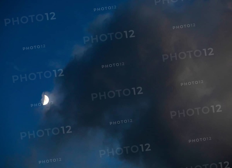 Evening sky with clouds and half moon
