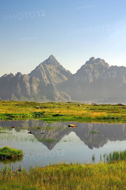 High mountains reflected in a small lake
