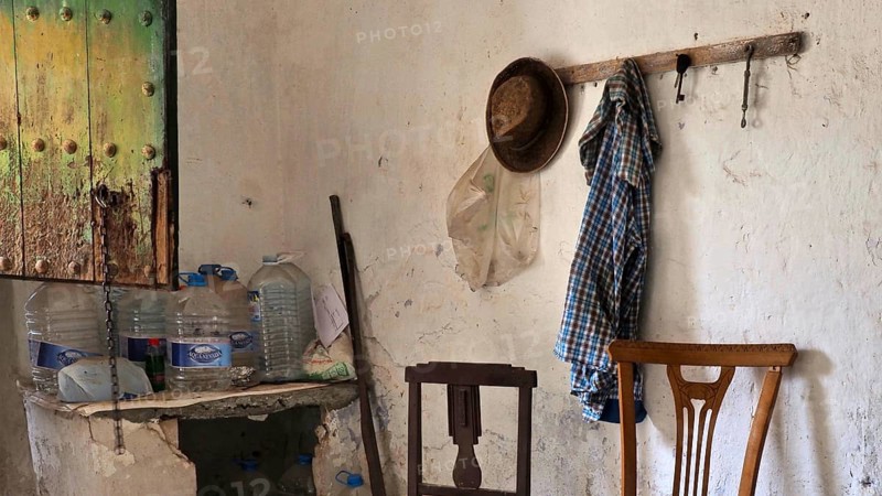 Abandoned finca as a workroom with chairs and wardrobe