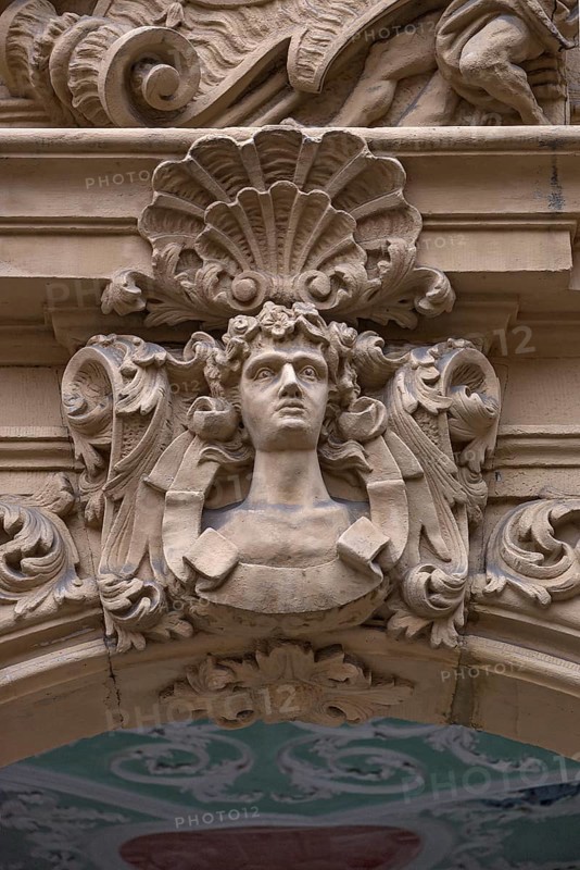 Man's head and shell in half relief above the entrance portal of the Baroque Boettinger House