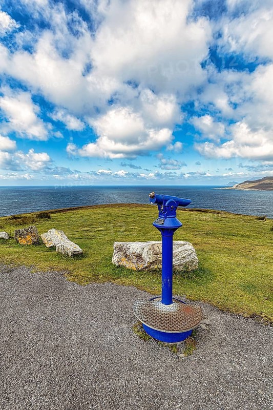 Viewpoint with blue telescope on the coast
