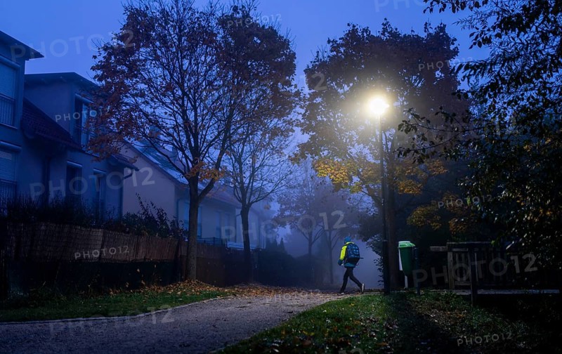 Schoolchild in foggy weather on the way to school in Markt Swabia