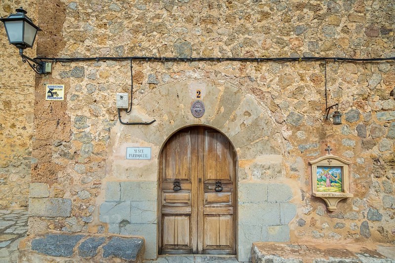 Wooden door with station Stations of the Cross