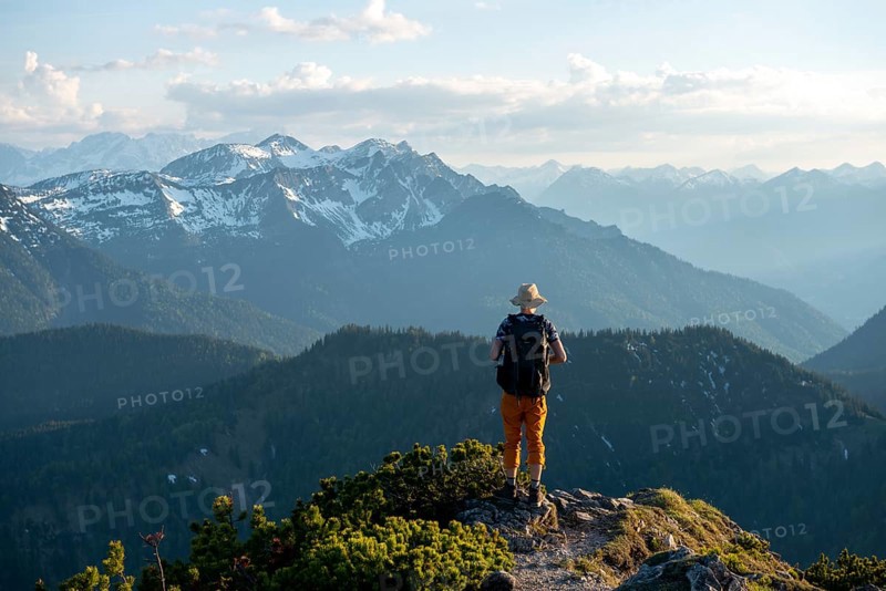 Hiker on hiking trail with mountain pines