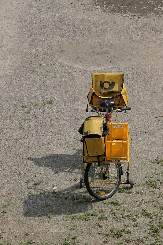 Yellow postal bike with postal bag and front luggage holder