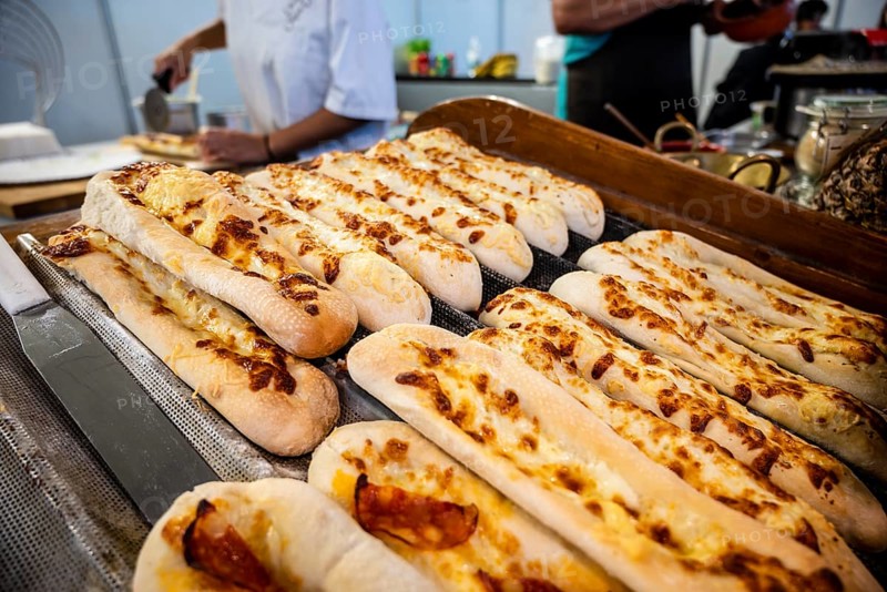 Long pizza bread with cheese and chourico sausage sold at Santa Iria Fair in Faro