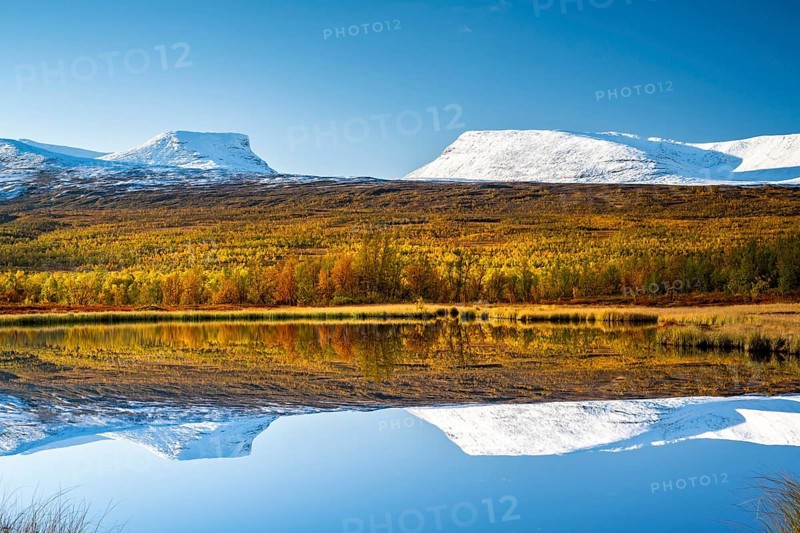 Mountain group Lapporten reflected in small pond