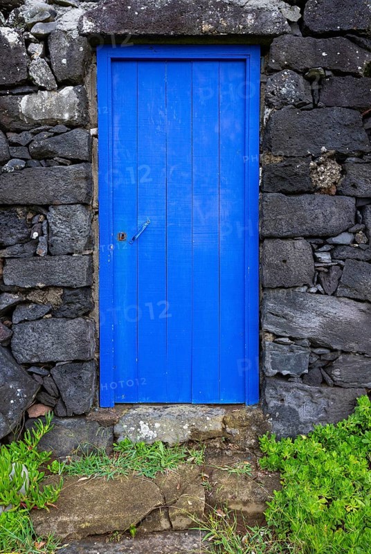 Lava stone house facade with blue front door