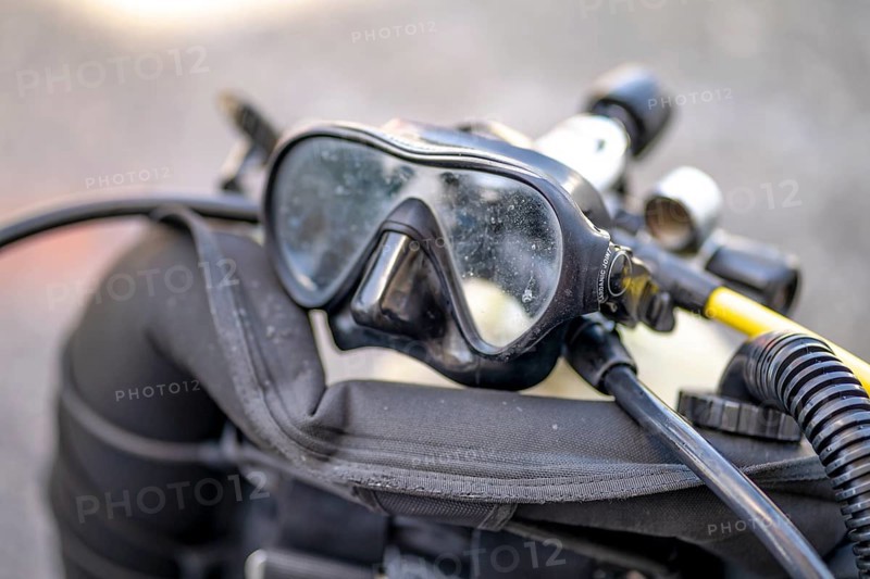Goggles and oxygen tank with regulator for scuba divers