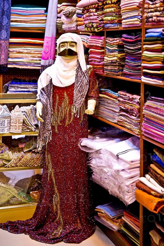 Traditional garments with burqa for Bedouin woman in the souq