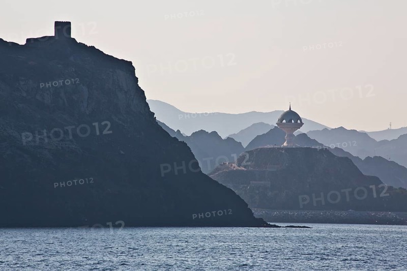 Coast near Muscat with view of fortifications and monument incense burner