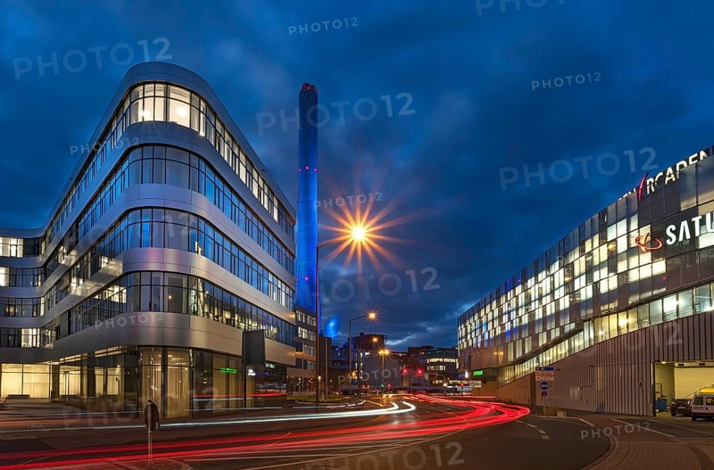 Chimney of the combined heat and power plant illuminated in the evening