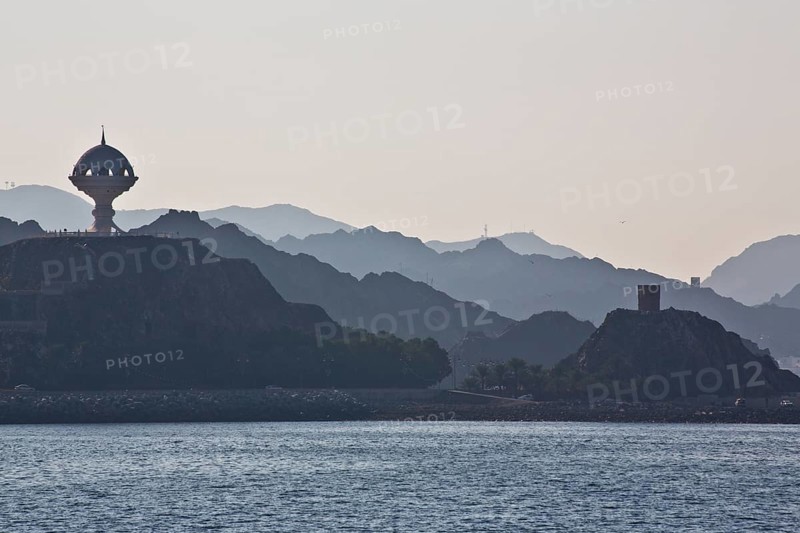 Coast near Muscat with view of fortifications and monument incense burner