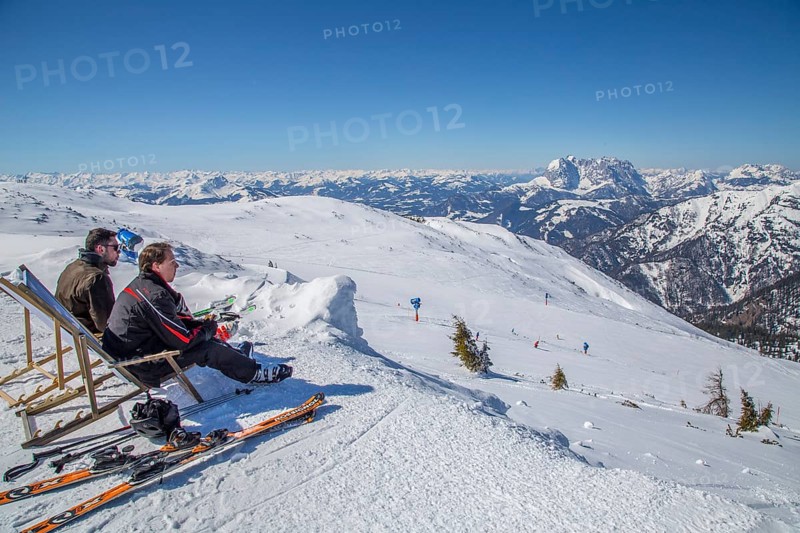 Skiers taking a break in a deck chair