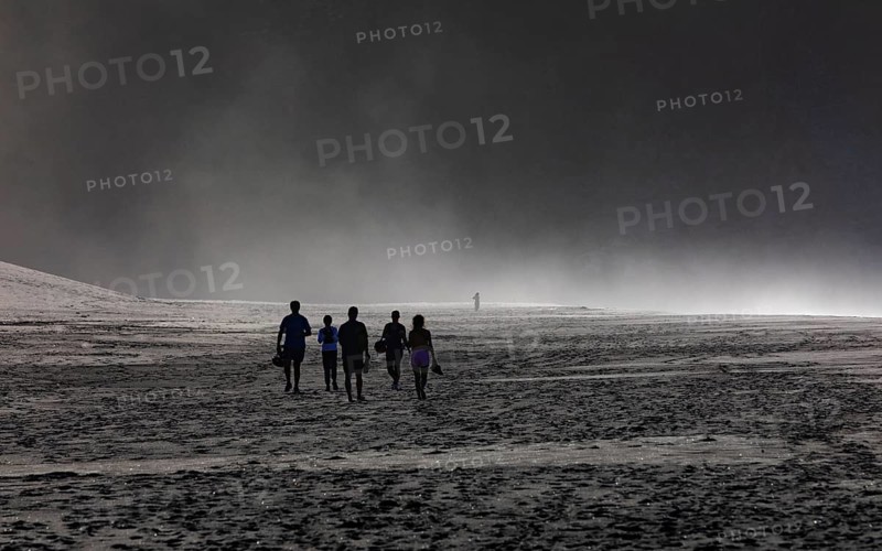 Group of people in the spray on the beach of Praia de Santa Barbara