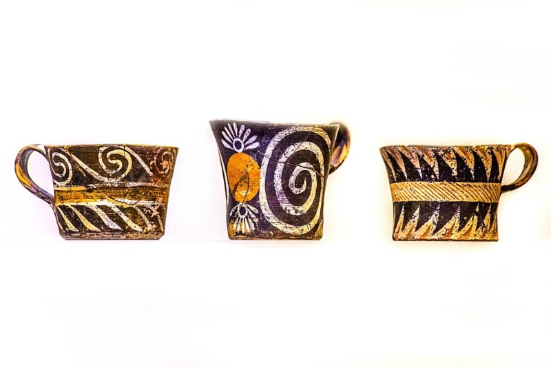 Cups decorated in white and polychrome Kamares style