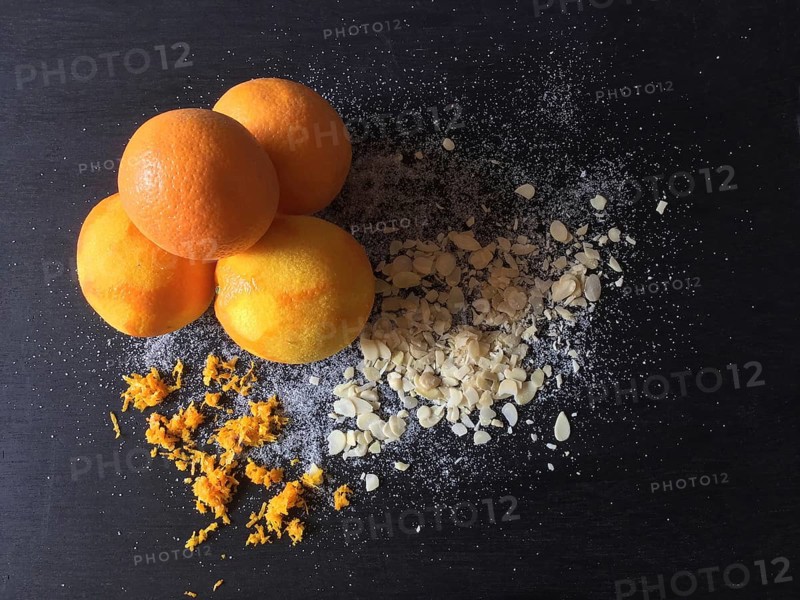Oranges with abrasion and almond slivers on slate board
