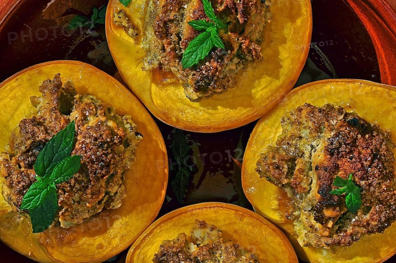 Dessert halved peaches with walnuts and mint leaf