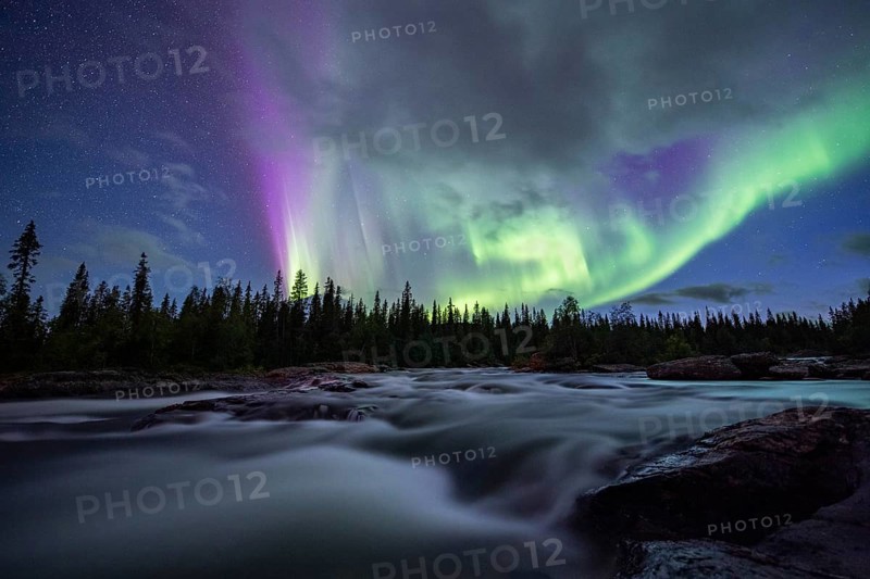 Northern Lights or Aurora Borealis over River Gamajahka or Kamajakka