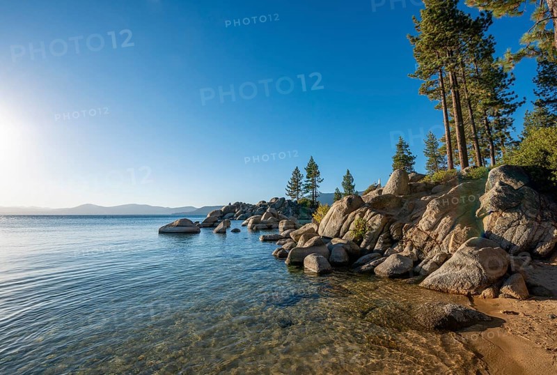 Sand beach and round stones in the water