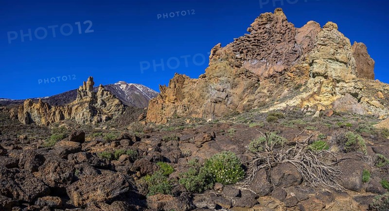 Colourful rocks of Roques de Garcia and Teide in the background